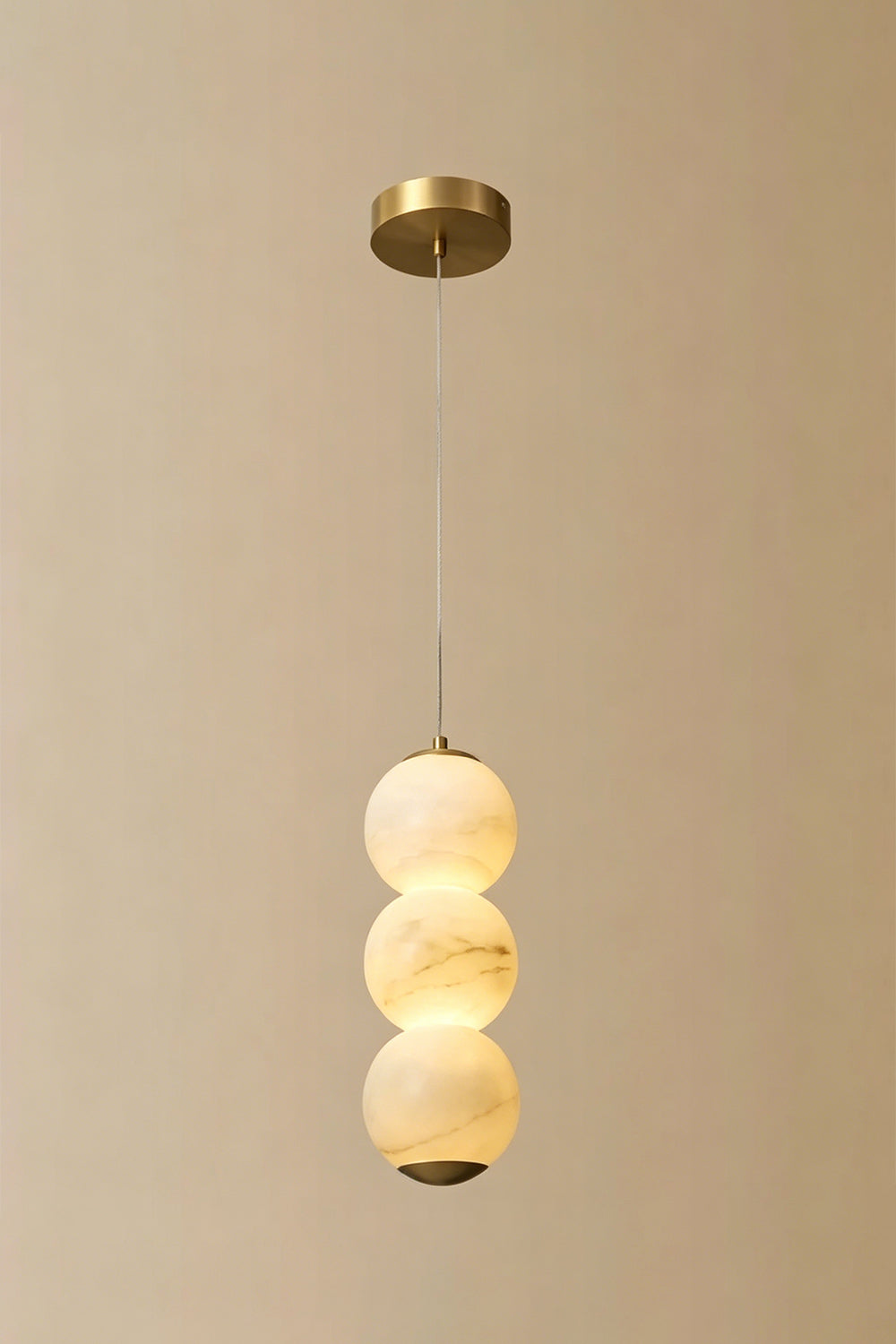 Imperial Epoch Alabaster Pendant Lamp | Metal, Alabaster | Full view of the three-sphere pendant variant against a beige background | vexa lamps