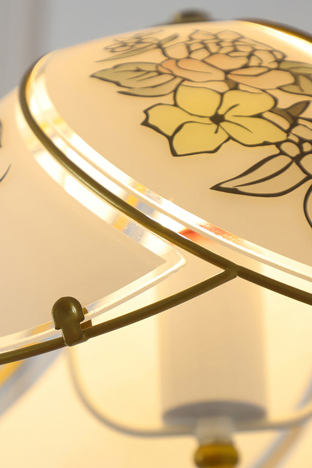 Lillian Retro Floral Pendant Lamp | Glass, Metal | Close-up focus on the illuminated white glass shade highlighting the delicate warm yellow floral painted line details | Detail shot | vexa lamps