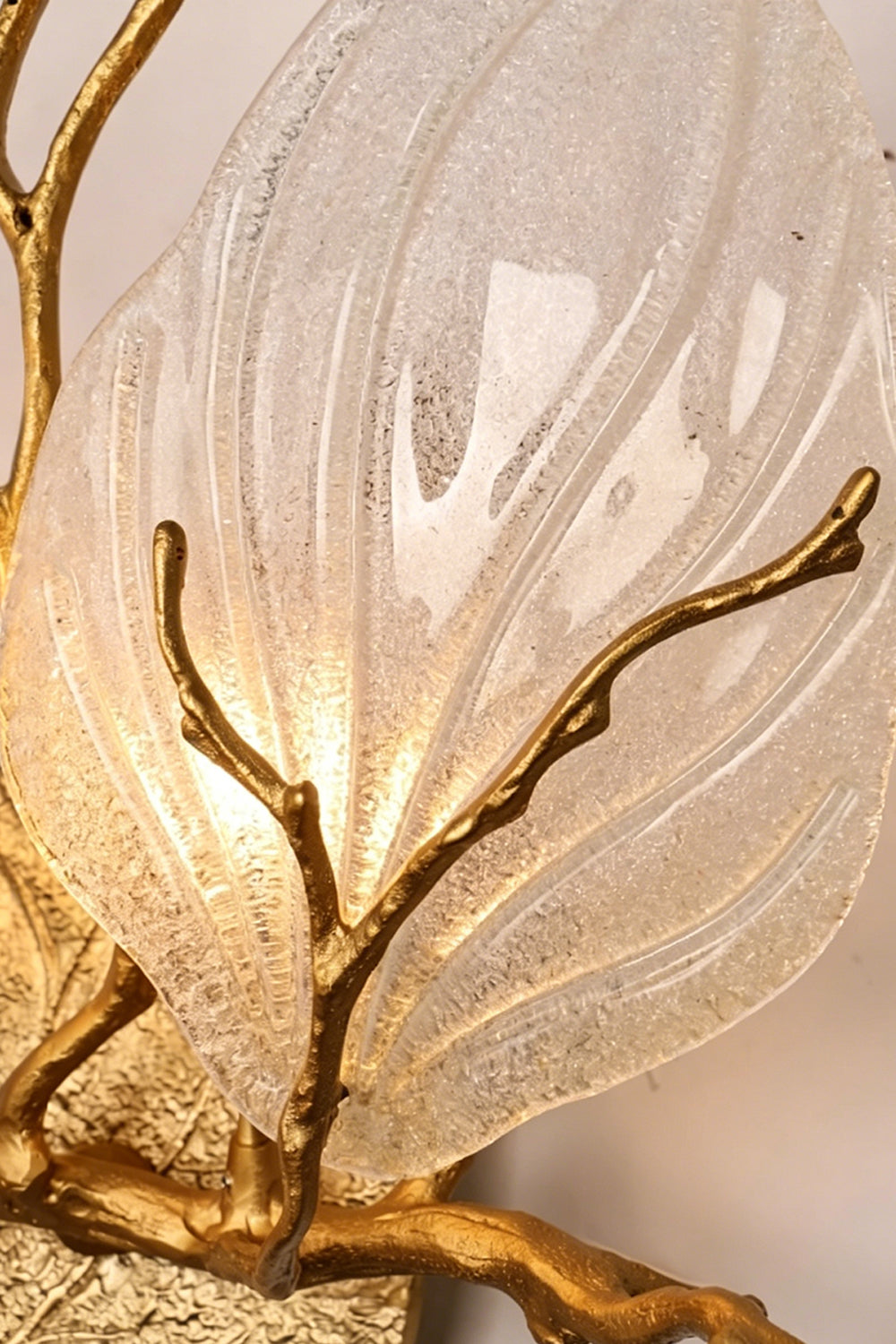 Magnolia Arbor Brass Wall Lamp | Brass, Glass | Extreme close-up of the textured clear glass shade, detailing the bubbles and icy texture under warm light | Detail shot | vexa lamps