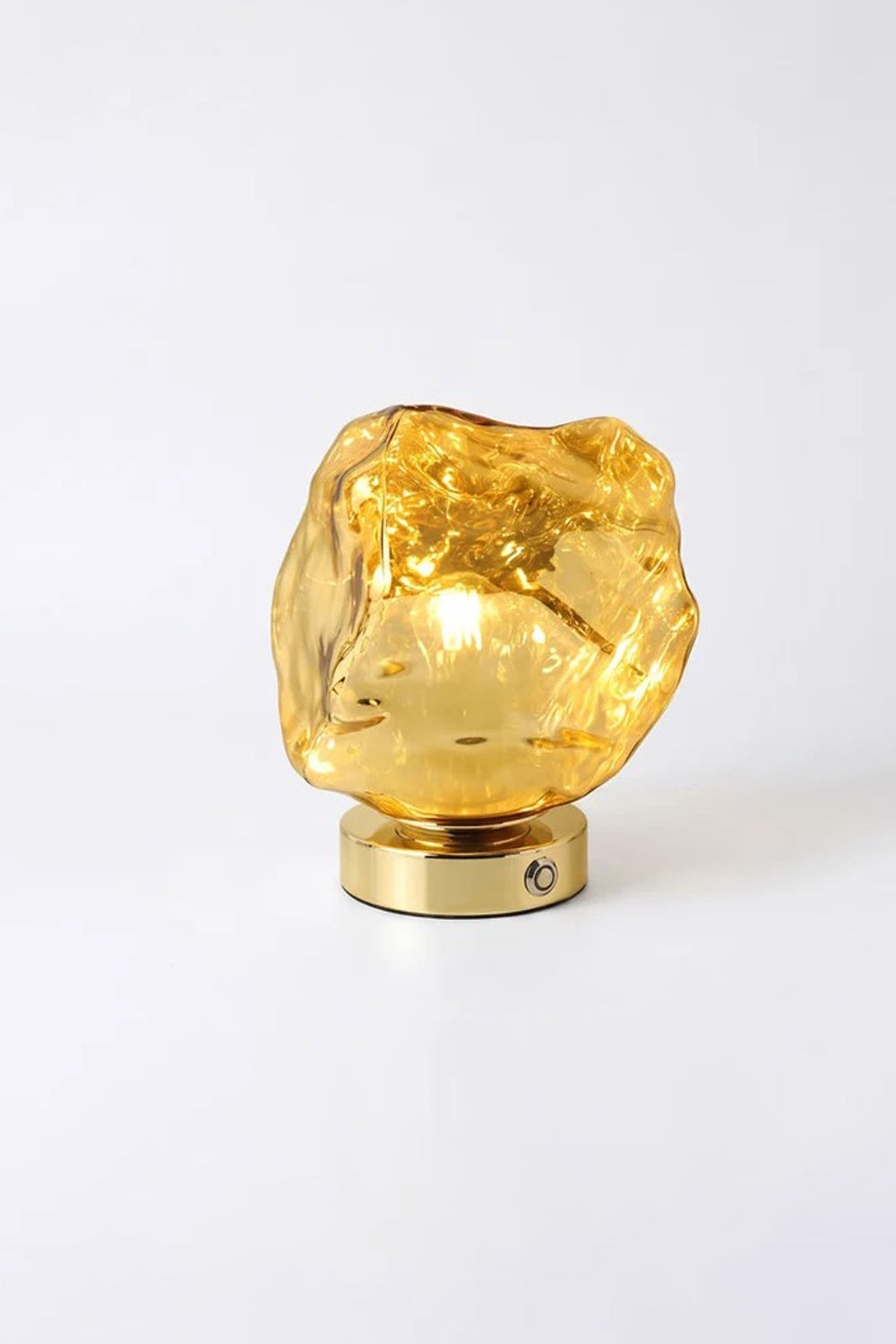 Vega Molten Metal Table Lamp with gold glass base reflecting light beautifully.