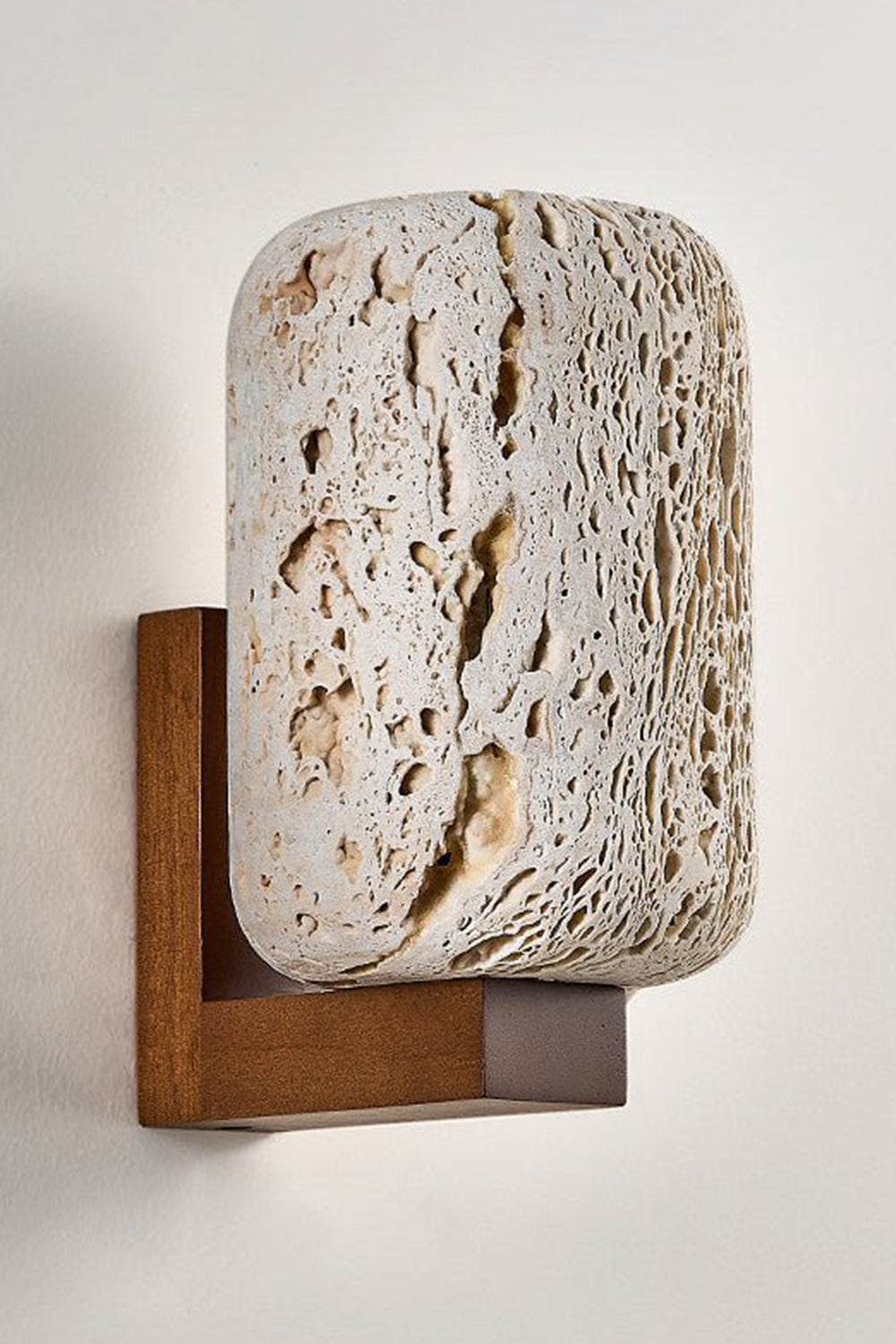 Unlit Wabi-Sabi travertine cylinder wall sconce | Travertine, Wood | Side perspective product view against a plain background | vexa lamps