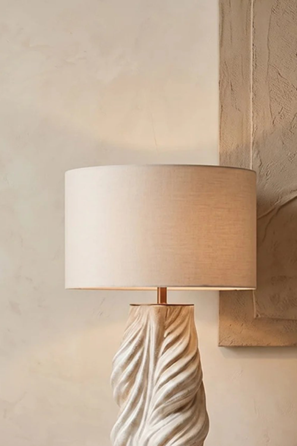 Adara Sculptural Ceramic Table Lamp | Ceramic, Fabric | Detailed close-up focus highlighting the texture of the off-white fabric drum shade and the upper twisted ceramic ridge detail | Detail shot | vexa lamps