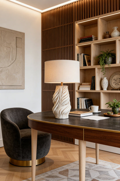 Adara Sculptural Ceramic Table Lamp | Ceramic, Fabric | Standing on a sleek executive writing desk next to a luxury black velvet chair in a modern home office with open shelving | vexa lamps