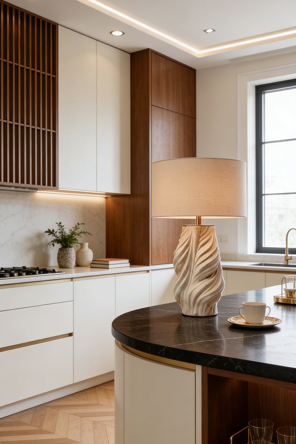 Adara Sculptural Ceramic Table Lamp | Ceramic, Fabric | Placed on a modern curved kitchen island countertop, casting a soft ambient glow next to minimalist wood cabinetry | vexa lamps
