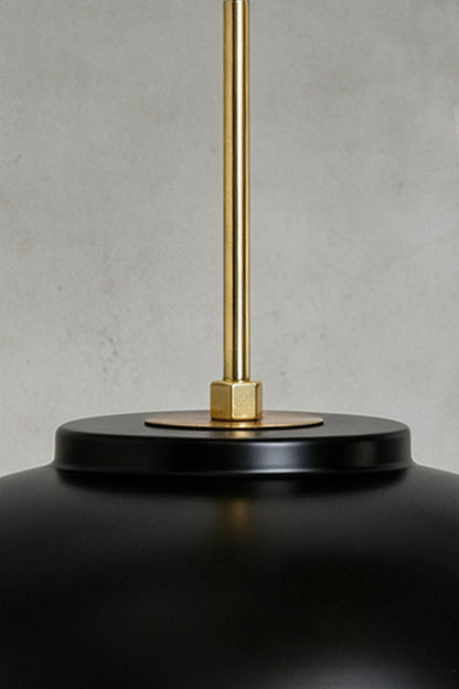 Close-up of the Adelaide Saucer Brass Pendant Light showcasing its metal structure and elegant design.