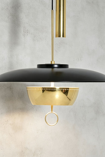 Adelaide Saucer Brass Pendant Light showcasing its sleek metal design and elegant acrylic shade.