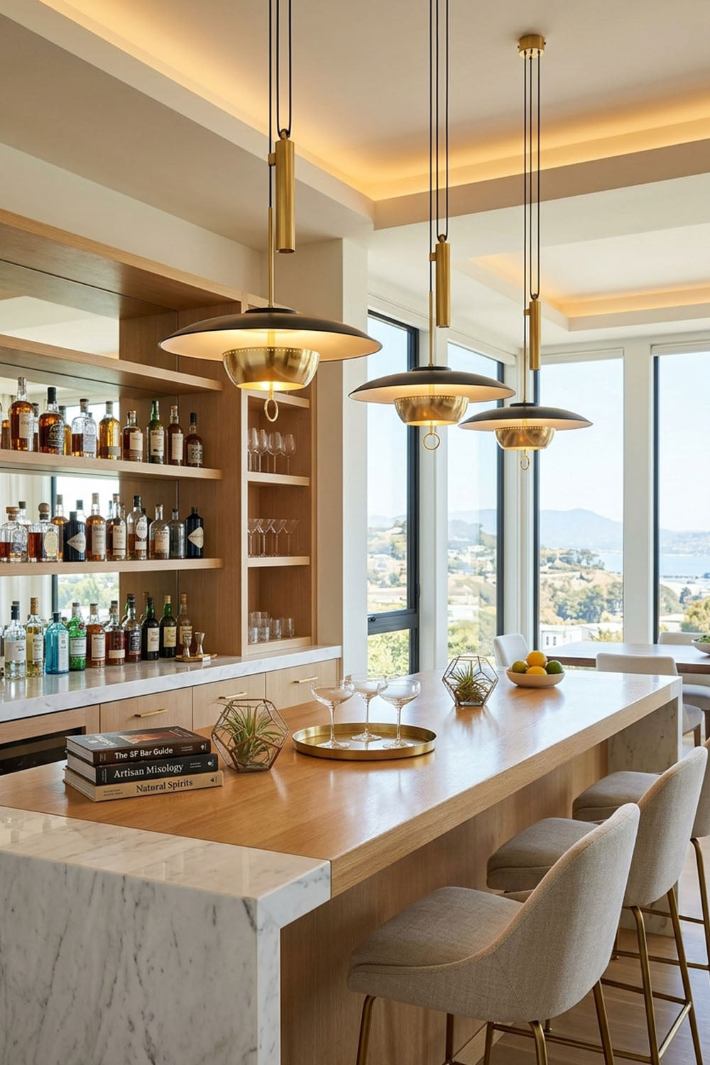 Adelaide Saucer Brass Pendant Light illuminating a modern kitchen bar with stylish decor and a stunning view.