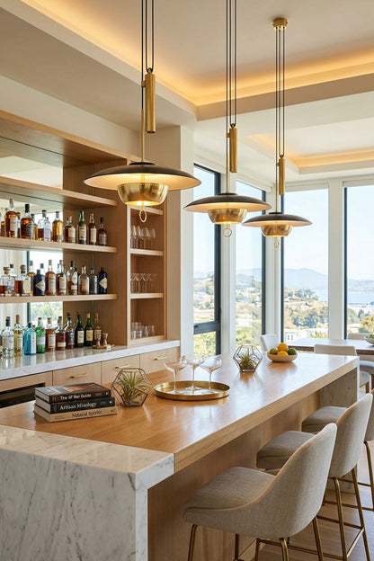 Adelaide Saucer Brass Pendant Light illuminating a modern kitchen bar with stylish decor and a stunning view.