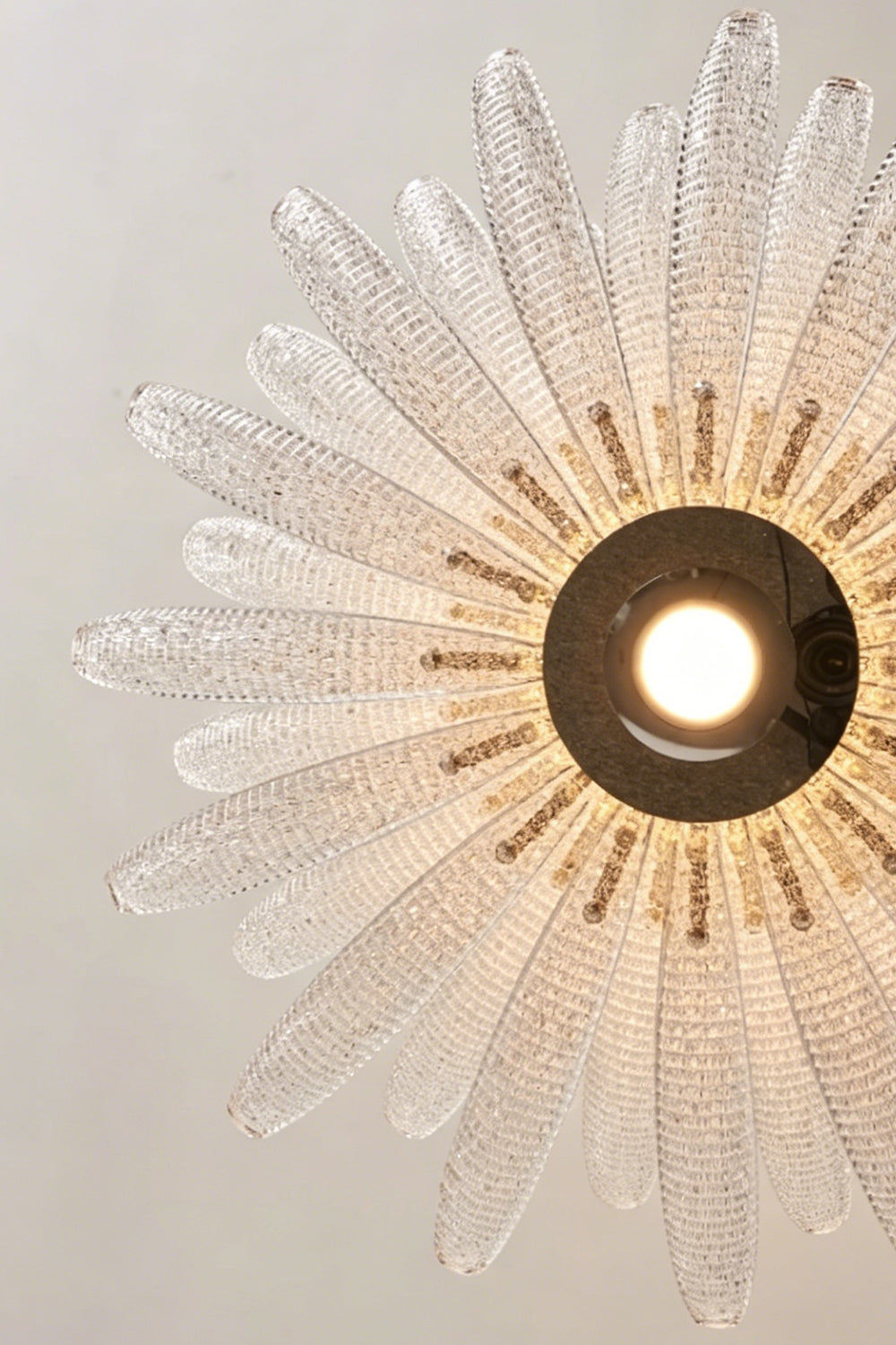Helios Agave Glass Starburst Chandelier | Glass, Metal | Looking directly up at the unlit chandelier, displaying the radial pattern of the clear textured glass pieces | Detail shot | vexa lamps