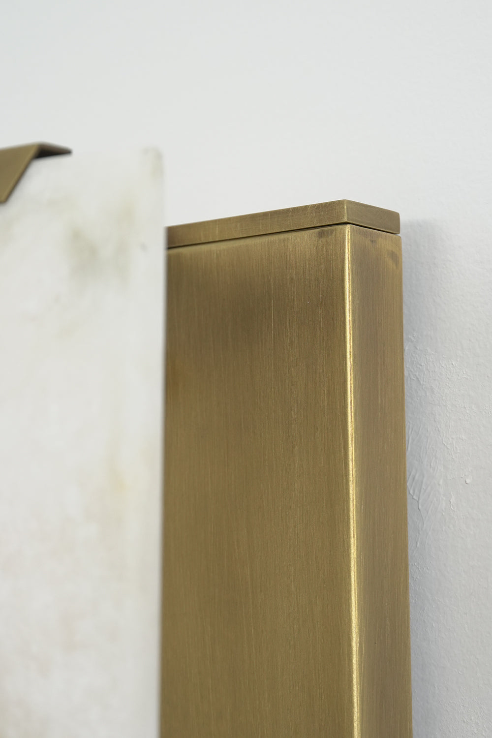 Brass hardware detail of alabaster wall lamp | Brass | Close-up of the metal frame and mounting connection | vexa lamps