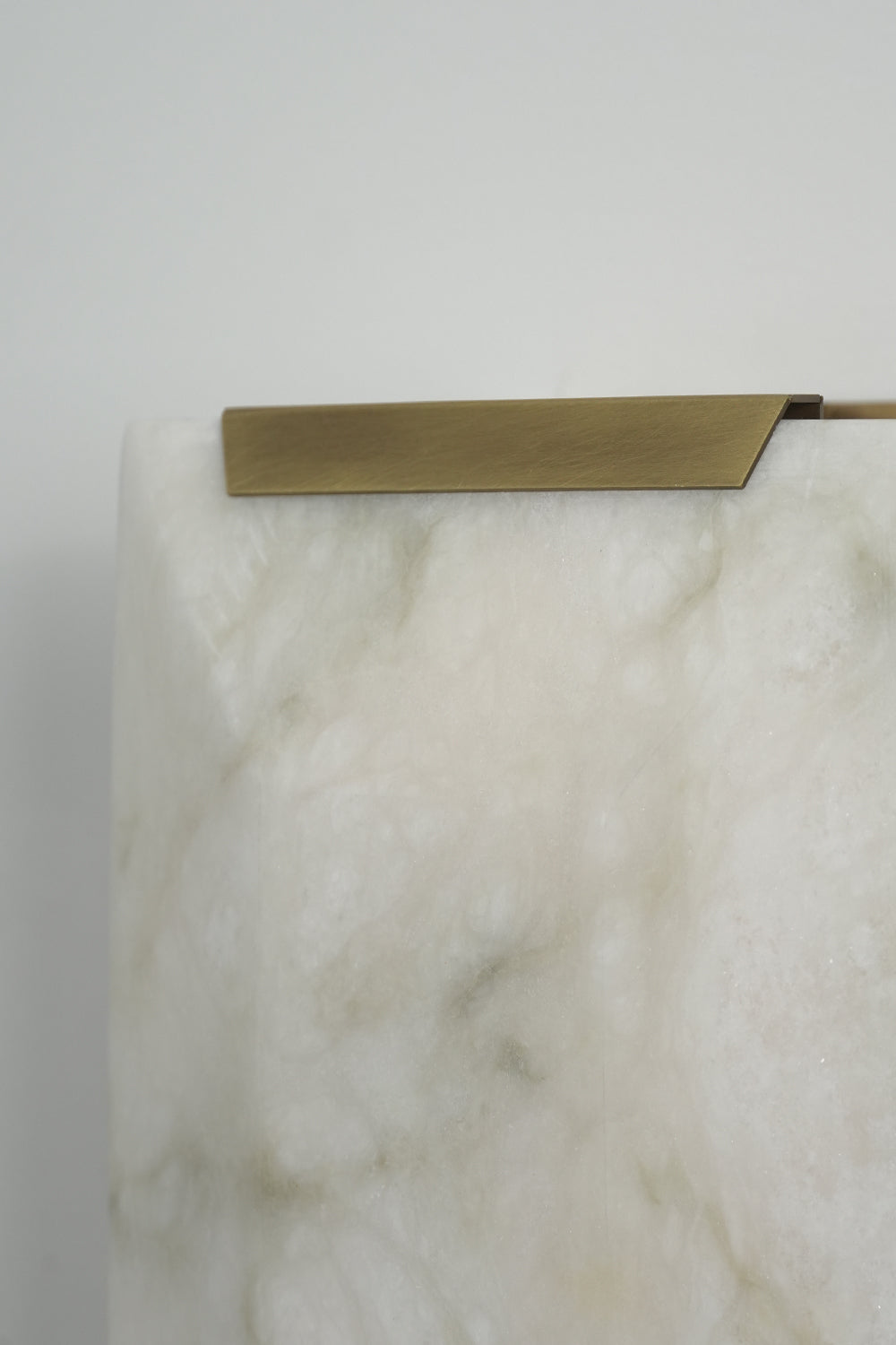 Brass cap detail of alabaster wall lamp | Brass, Alabaster | Close-up showing the metallic edge and stone texture | vexa lamps