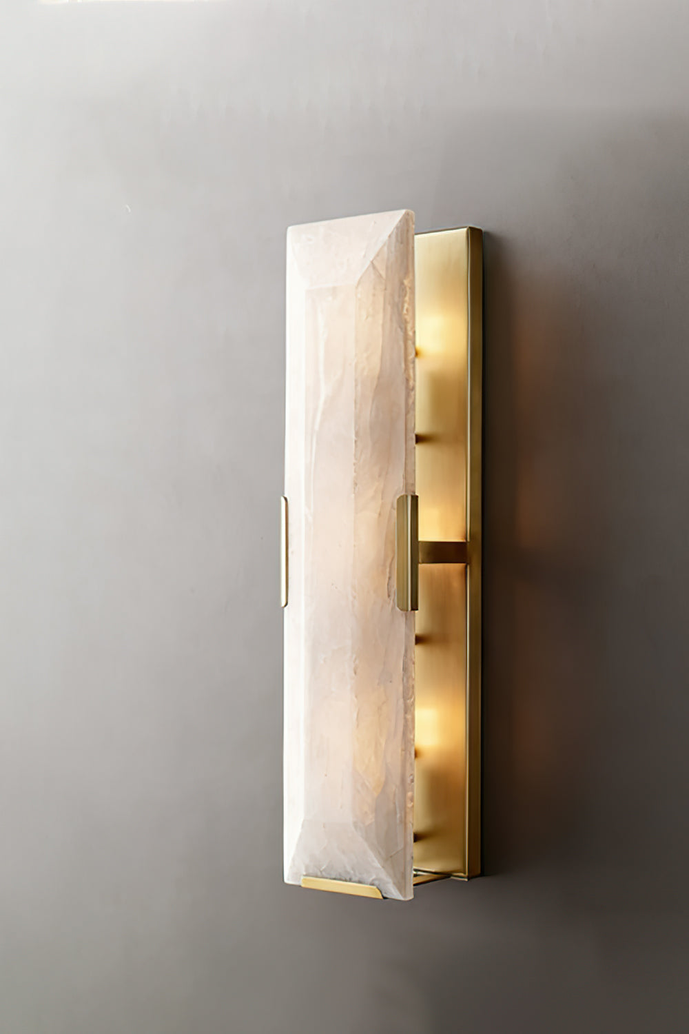 Lit rectangular alabaster wall sconce | Brass, Alabaster | Front view against a neutral background | vexa lamps