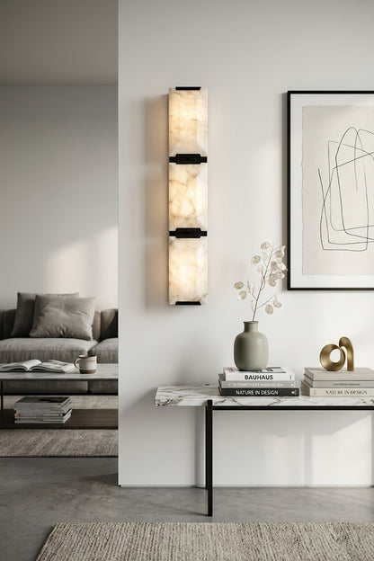 Vertical 3-panel alabaster wall lamp | Brass, Alabaster | Installed in a high-ceiling gallery room with a console | vexa lamps