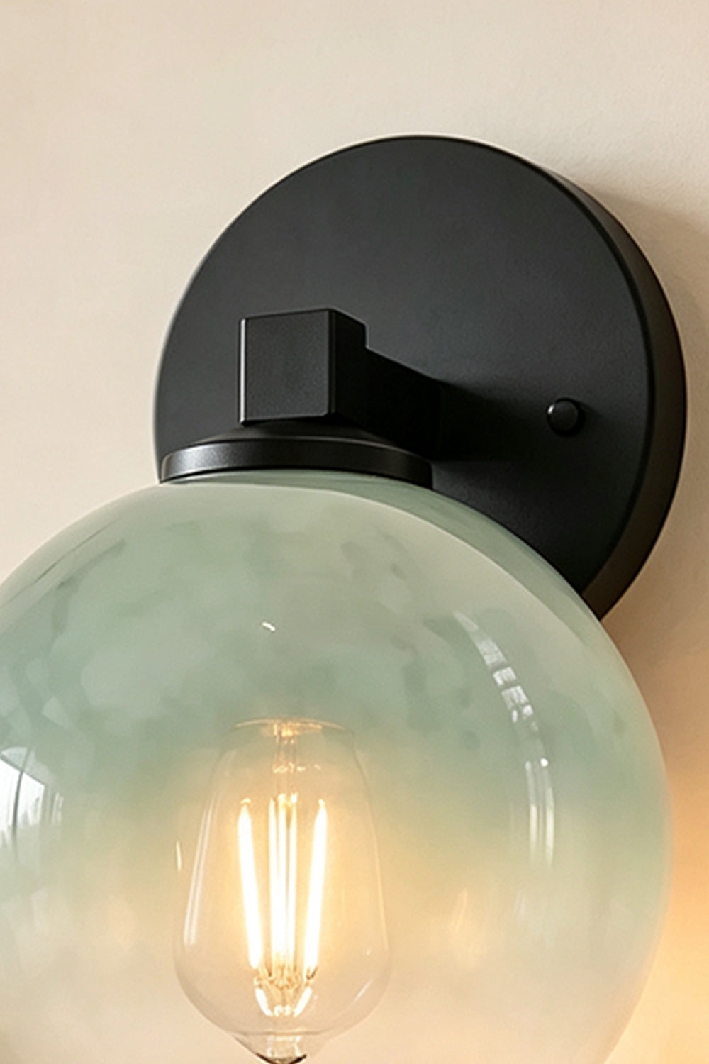 Alba Ombre Glass Wall Sconce featuring hand-blown green and clear glass with a modern black iron mount.