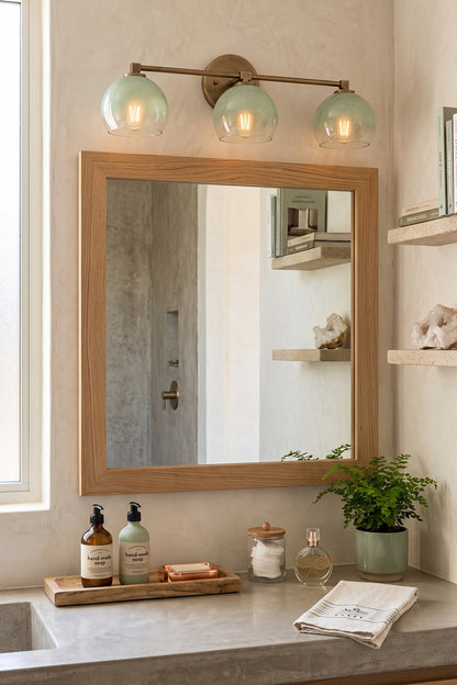 Alba Ombre Glass Wall Sconce above a mirror in an elegantly designed bathroom, featuring hand-blown glass globes.