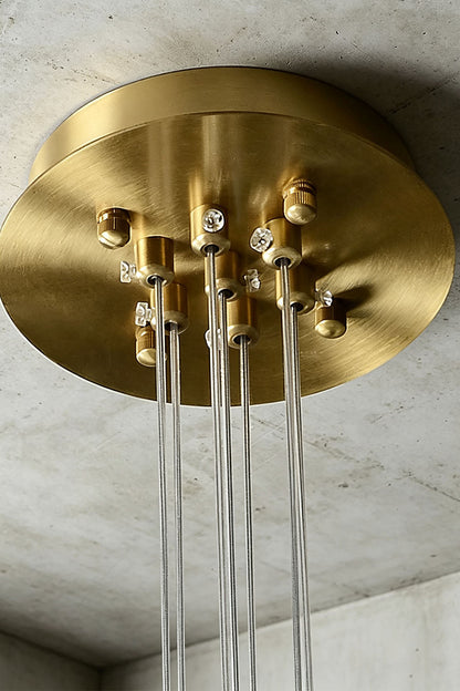 Amandine Alabaster Globe Cluster Pendant Light ceiling fixture with a sleek brass finish and hanging glass rods.