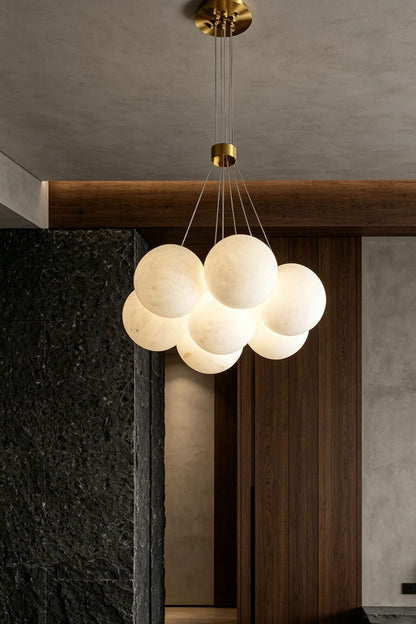 Amandine Alabaster Globe Cluster Pendant Light in a modern dining room setting with polished interiors.
