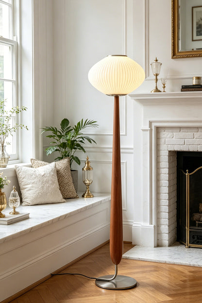 Arden Walnut Floor Lamp | Wood, Metal, Fabric | Placed elegantly next to a built-in white window bench seat in a sunlit classical lounge room with a fireplace | vexa lamps