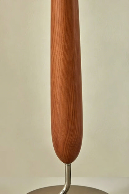 Arden Walnut Floor Lamp | Wood, Metal, Fabric | Detailed close-up focus on the sculpted teardrop-shaped central body highlighting the natural rich brown walnut wood grain texture | Detail shot | vexa lamps