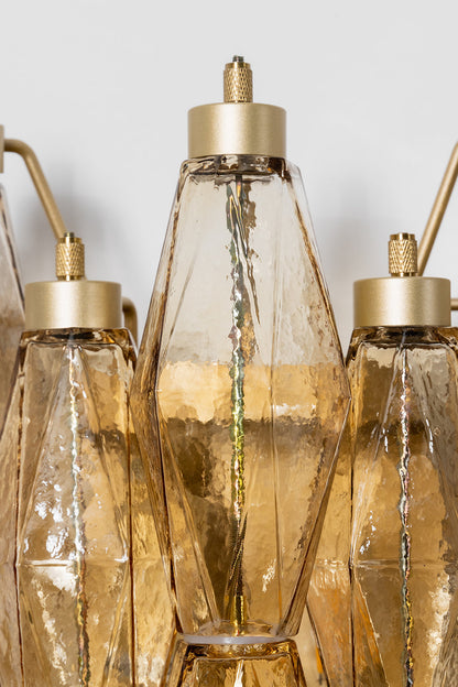 Close-up of metal hardware and amber glass prisms | Metal, Glass | Top detail showing the brass-finish hangers | vexa lamps
