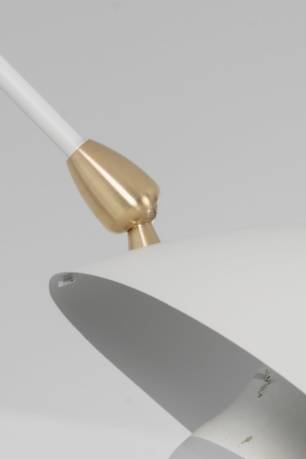 Brass articulation hardware on white metal arm | Metal | Macro shot showing the high-quality joint connection | vexa lamps