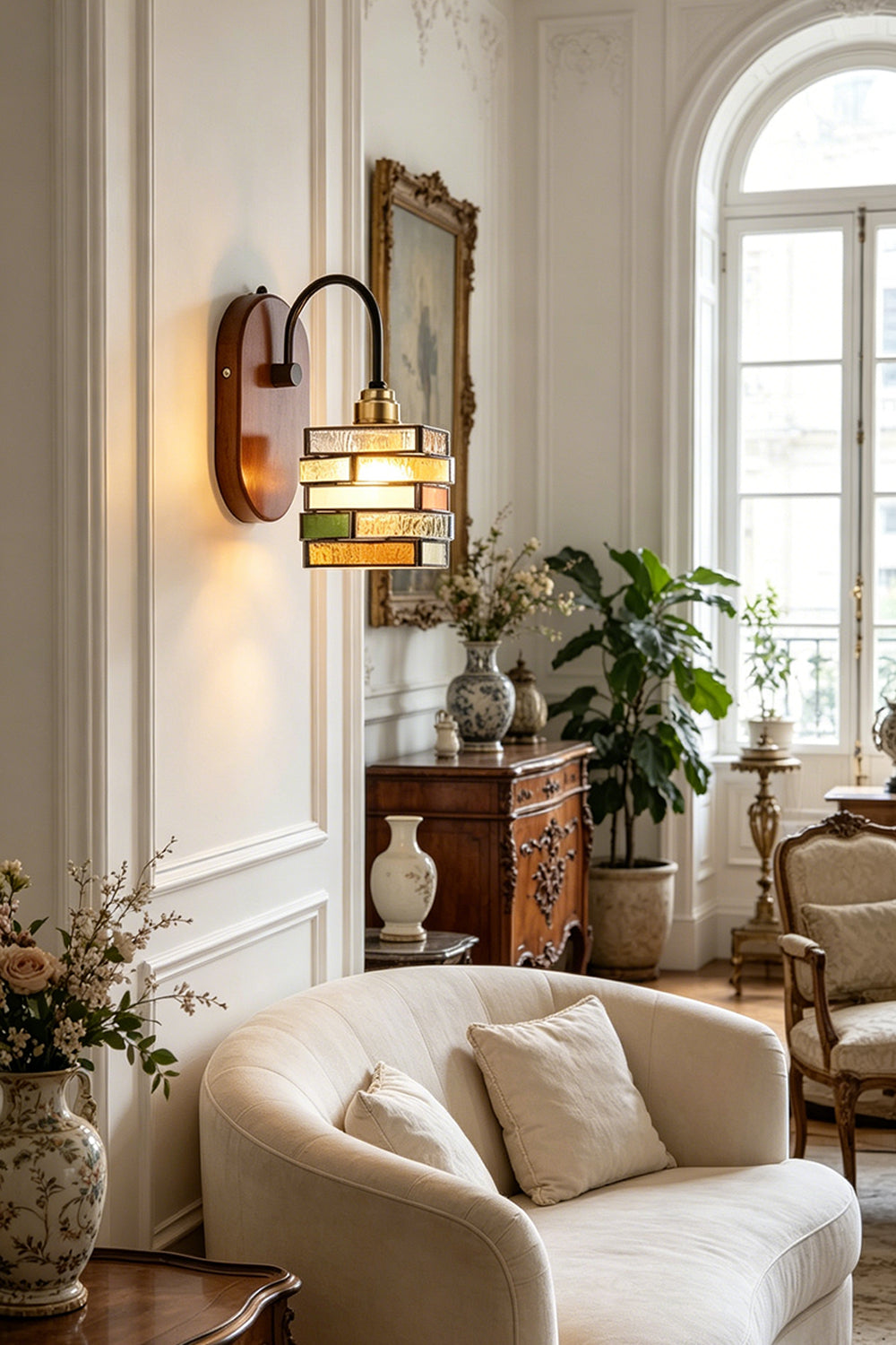 Artisan Mosaic Stained Glass Wall Sconce illuminating a stylish living room with elegant furniture and decor.