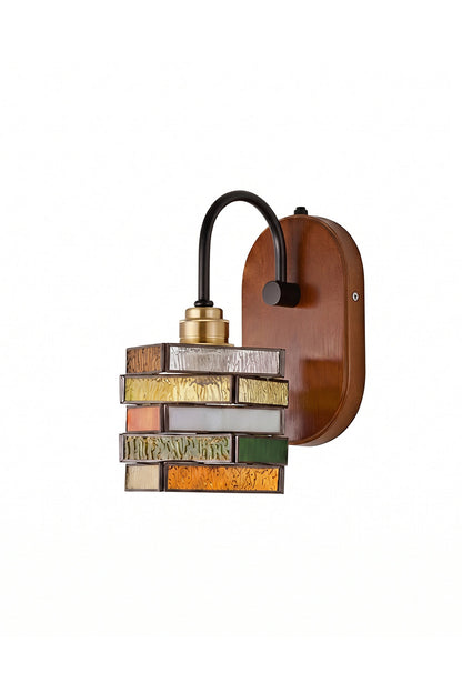 Artisan Mosaic Stained Glass Wall Sconce featuring a geometric, layered stained-glass design and curved dark iron arm.