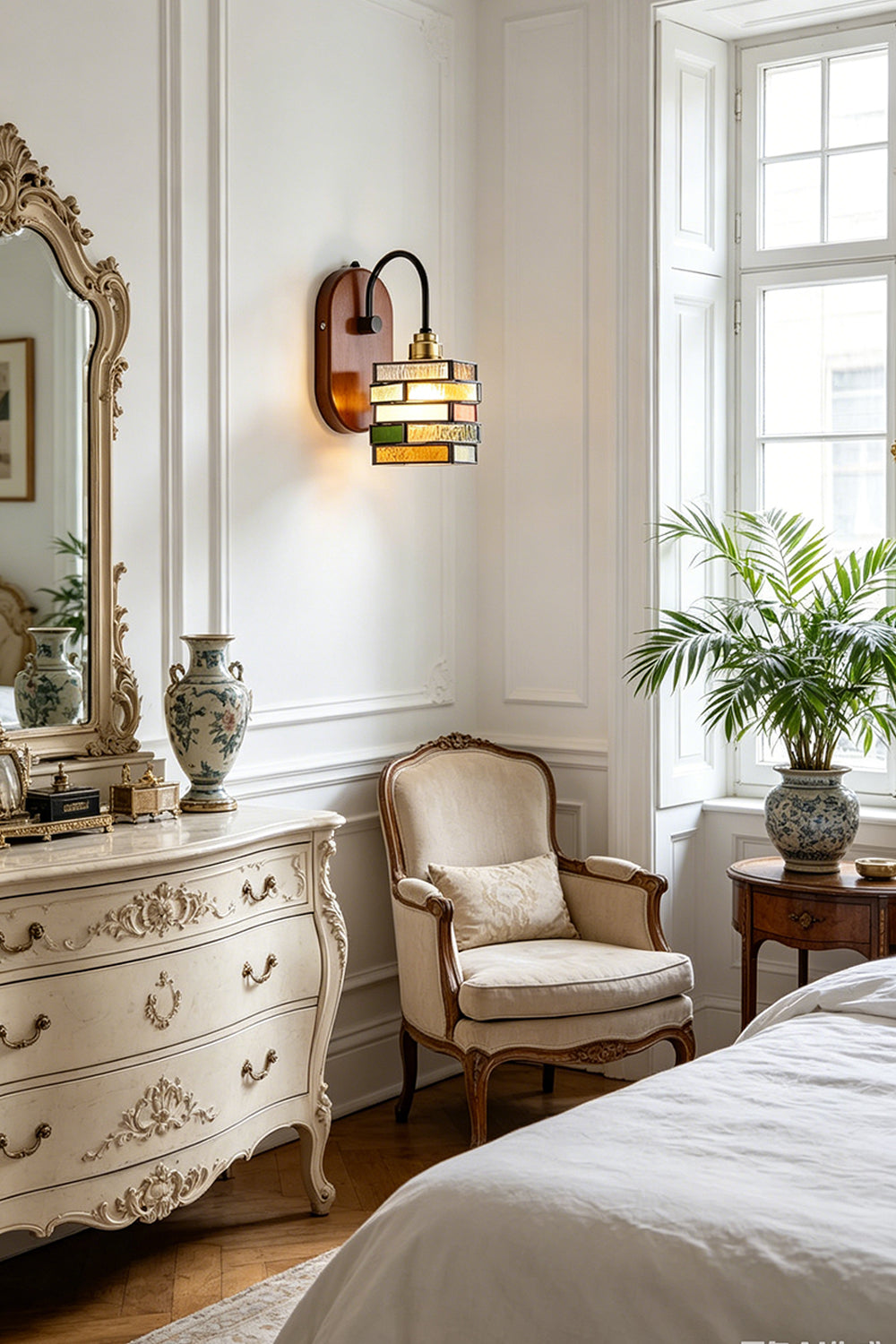 Artisan Mosaic Stained Glass Wall Sconce illuminating a stylish bedroom with vintage furniture and decor.