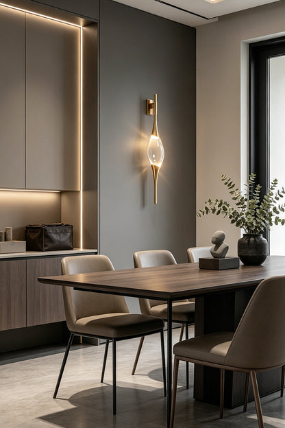 Astraea Crystal Linear Wall Sconce | Crystal, Brass | Providing sophisticated accent lighting on a dark grey wall in a contemporary dining room setup | vexa lamps