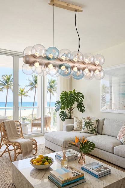 Astraea Linear Prismatic Globe Chandelier illuminating a modern living space with beach view and stylish decor.