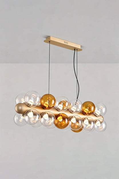 Astraea Linear Prismatic Globe Chandelier featuring hand-blown glass spheres in a brushed champagne-gold finish.