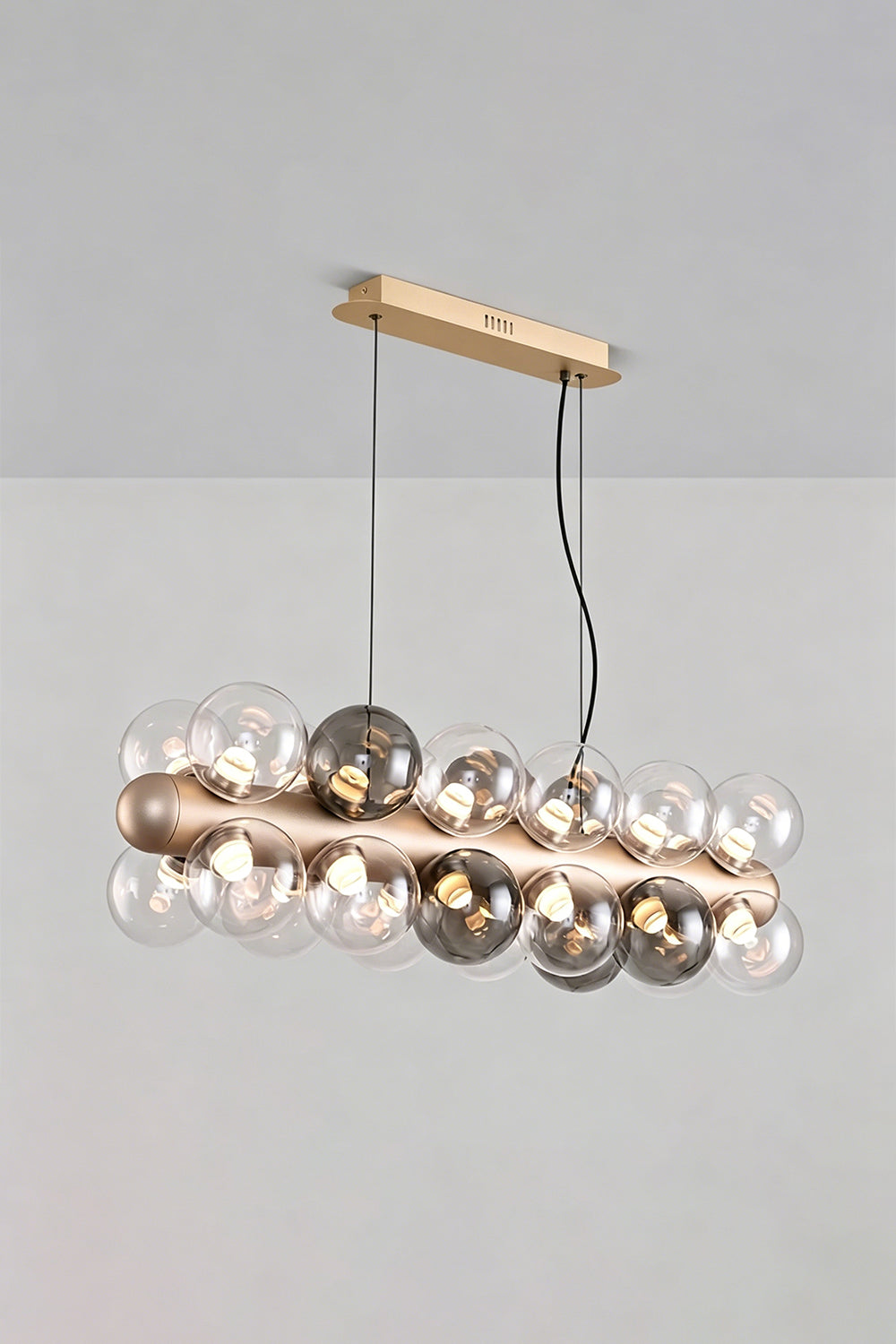 Astraea Linear Prismatic Globe Chandelier features hand-blown glass spheres and brushed champagne-gold finish, ideal for modern decor.