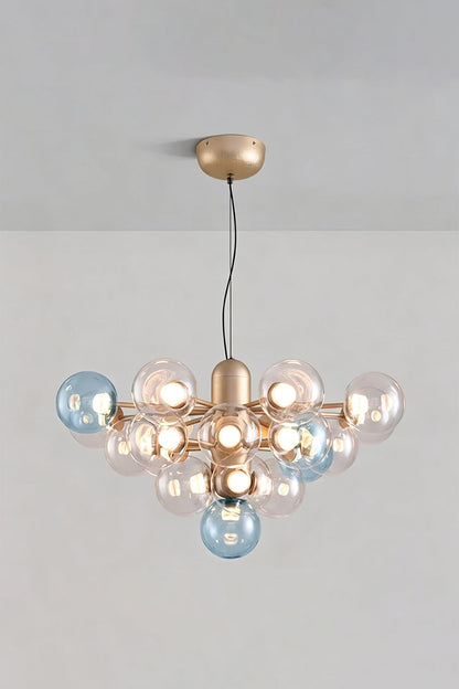 Astraea Prismatic Globe Chandelier | Glass, Metal | Studio view of the ocean blue glass bubble variant fully illuminated against a plain grey backdrop | vexa lamps