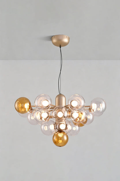 Astraea Prismatic Globe Chandelier | Glass, Metal | Studio view of the amber yellow glass bubble variant fully illuminated against a plain grey backdrop | vexa lamps