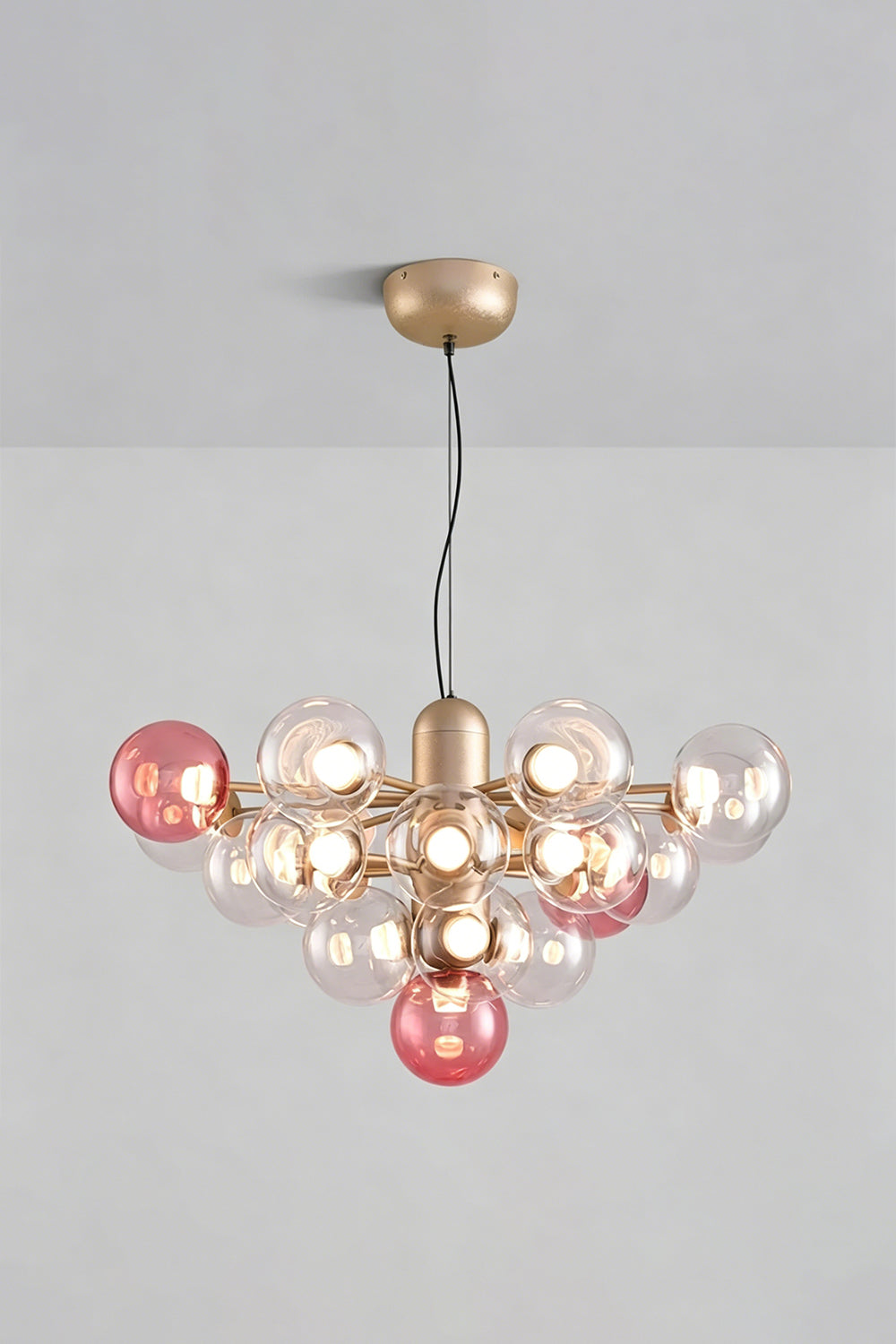 Astraea Prismatic Globe Chandelier | Glass, Metal | Studio view of the romantic rose pink glass bubble variant fully lit against a plain grey background | vexa lamps
