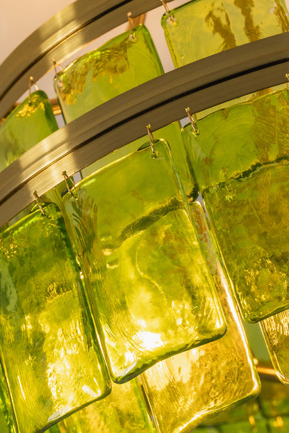 Aura Verdant Tiered Green Glass Ceiling Light | Metal, Glass | Close-up macro view highlighting the fiery golden-green glow through the textured glass panels | Detail shot | vexa lamps