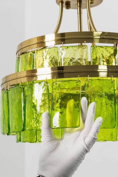 Aura Verdant Tiered Green Glass Ceiling Light | Metal, Glass | A white-gloved hand adjusting the bottom section of the two-tier green glass fixture | Detail shot | vexa lamps