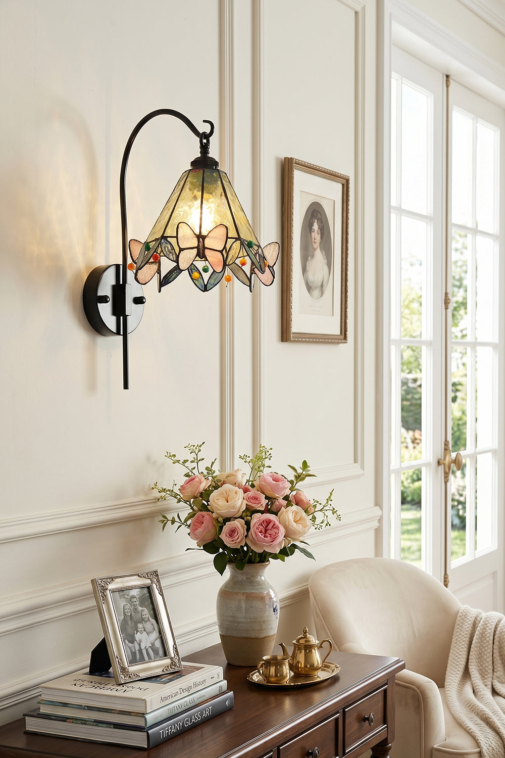 Aura Vine Stained Glass Wall Sconce | Glass, Metal | Mounted on a paneled wall above a vintage wooden cabinet with a glass vase holding pink flowers | vexa lamps