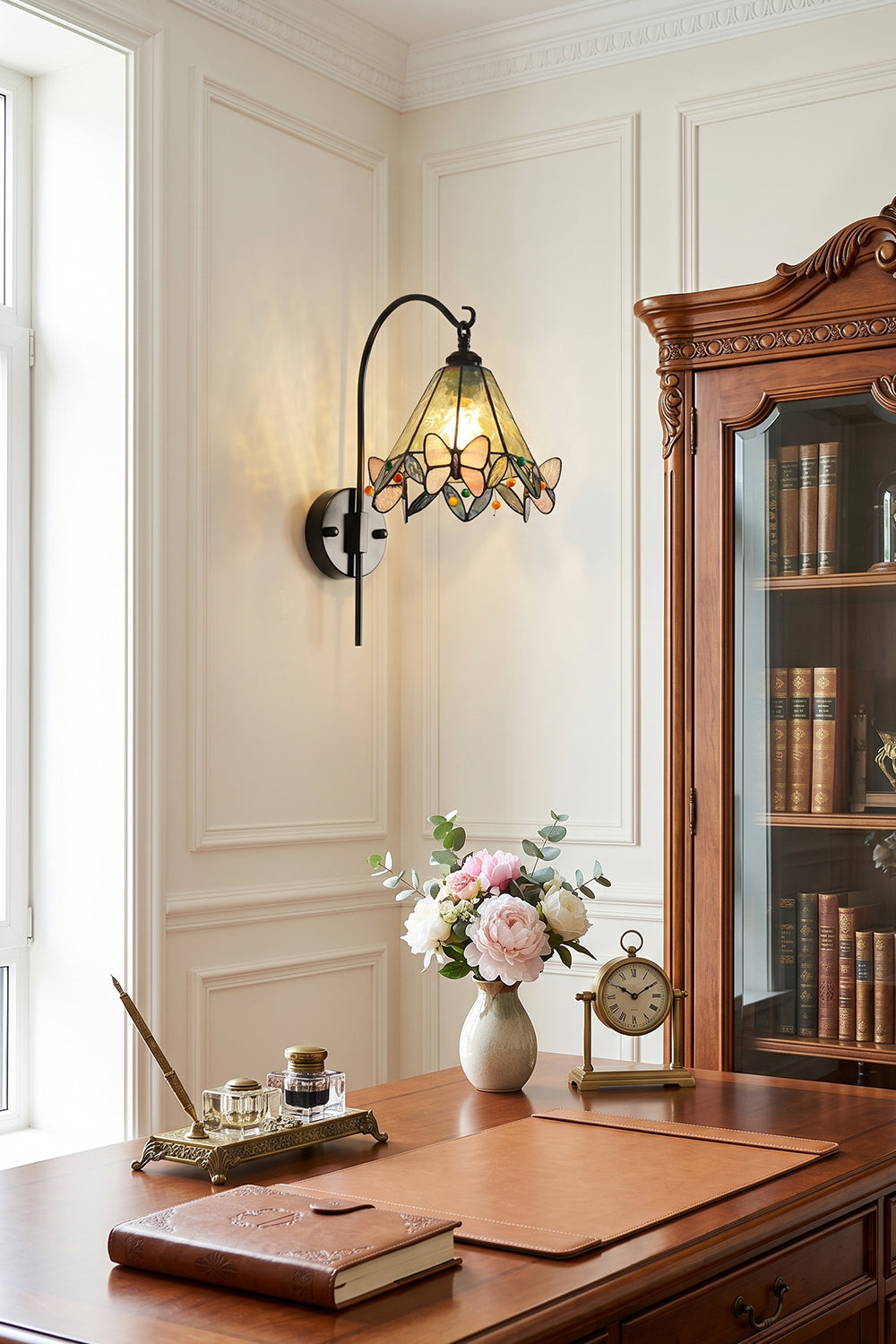 Aura Vine Stained Glass Wall Sconce | Glass, Metal | Wall-mounted next to a large window in a classic study room, illuminating a vintage wooden executive desk | vexa lamps