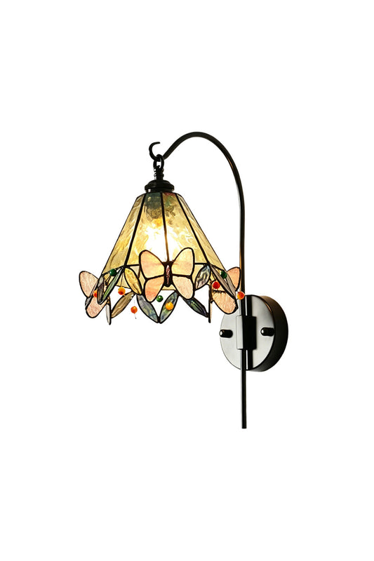 Aura Vine Stained Glass Wall Sconce | Glass, Metal | Fully lit Tiffany-style stained glass wall sconce with yellow textured panels and pink butterfly accents hanging from a curved black metal arm | Isolated lit product shot on white background | vexa lamps