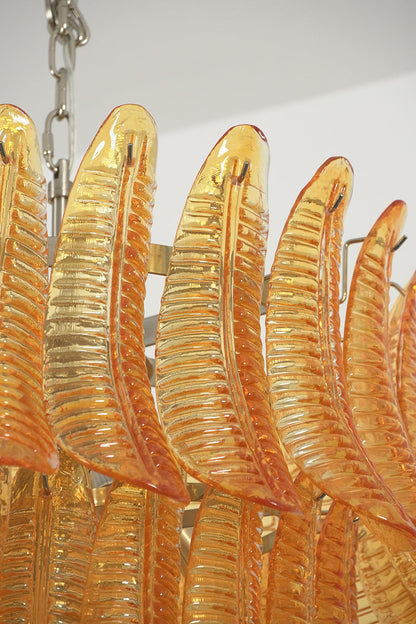 Aurelia Helix Amber Glass Cascade Chandelier featuring hand-poured amber glass plumes in a spiral design.