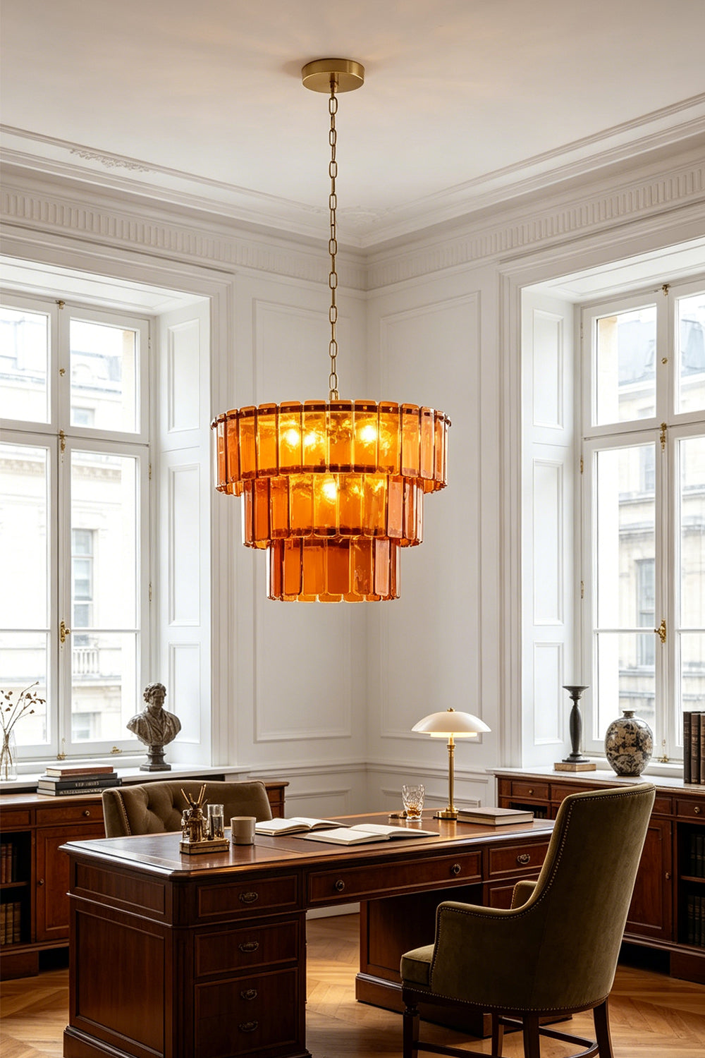 Aurelia Tiered Amber Glass Chandelier hanging in a stylish office setting illuminating the space with warm light.