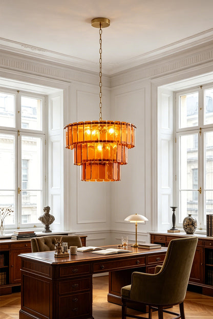 Aurelia Tiered Amber Glass Chandelier hanging in a stylish office setting illuminating the space with warm light.
