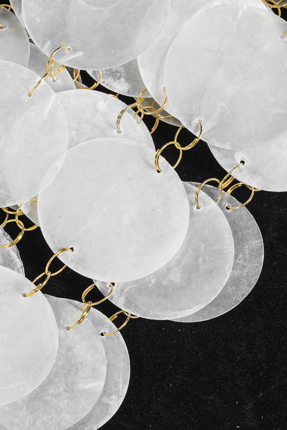 Aurelia Tiered Capiz Table Lamp | Capiz Shell, Metal | Macro close-up under studio lighting highlighting the overlapping natural texture of the white capiz shells | Detail shot | vexa lamps