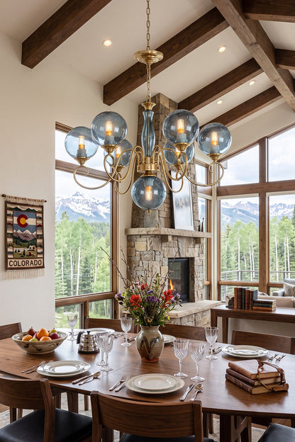 Aveline Globe Cluster Chandelier | Colored Glass and Brass | Blue glass version in a high-ceiling dining room with scenic mountain views | vexa lamps