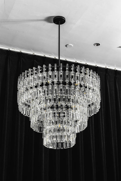 Aven Tiered Glass Prism Chandelier | Glass, Metal | Frontal centered shot of the unlit black metal and clear glass link chandelier variant on a dark studio background | vexa lamps