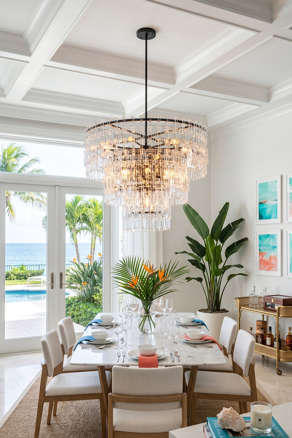 Aven Tiered Glass Prism Chandelier | Glass, Metal | Suspended as a luxurious centerpiece over a wooden table in a bright coastal villa dining room overlooking the ocean | vexa lamps