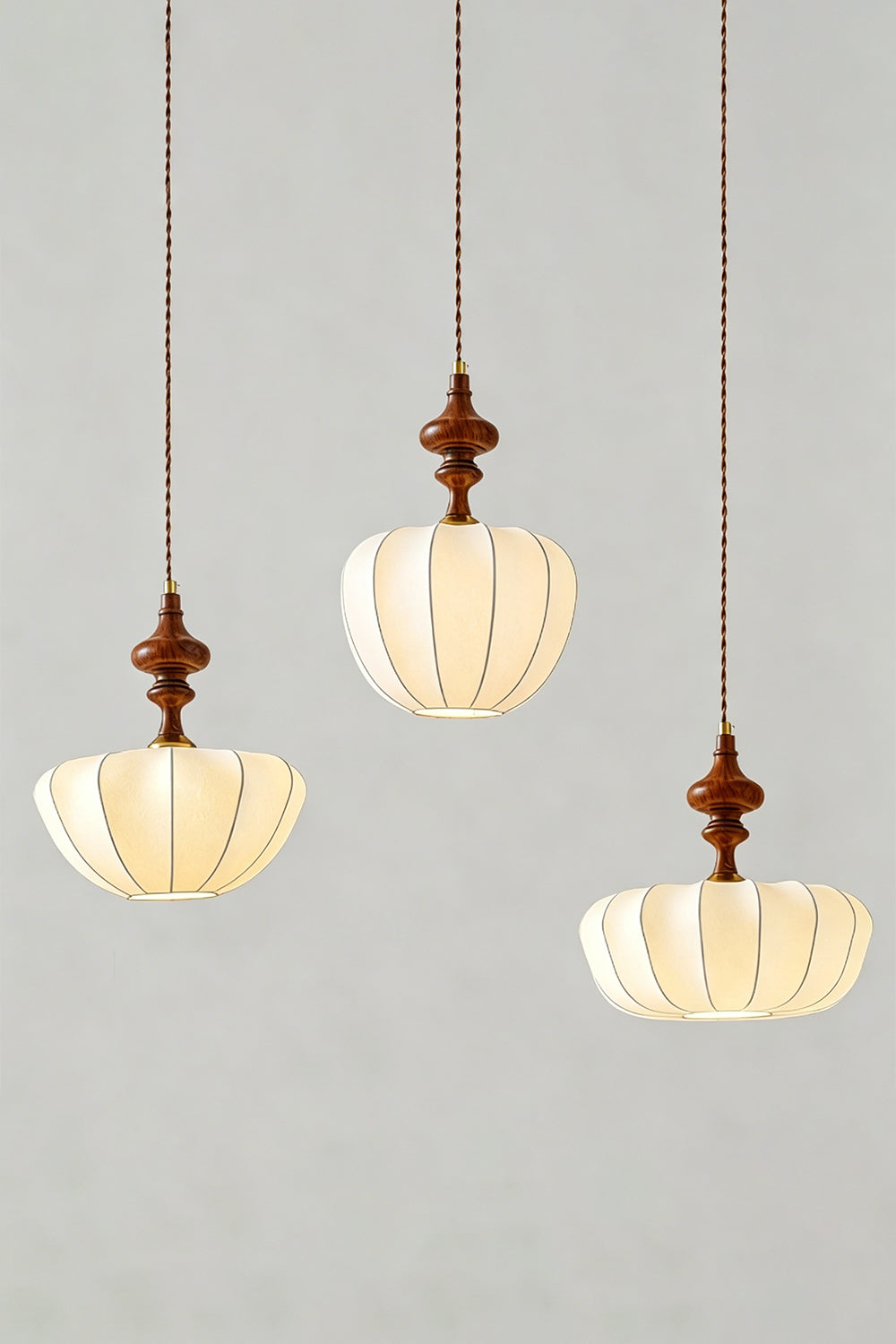 Baird Mid-Century Silk Pendant Light trio featuring lobed silk shades and walnut-toned wooden spindles.
