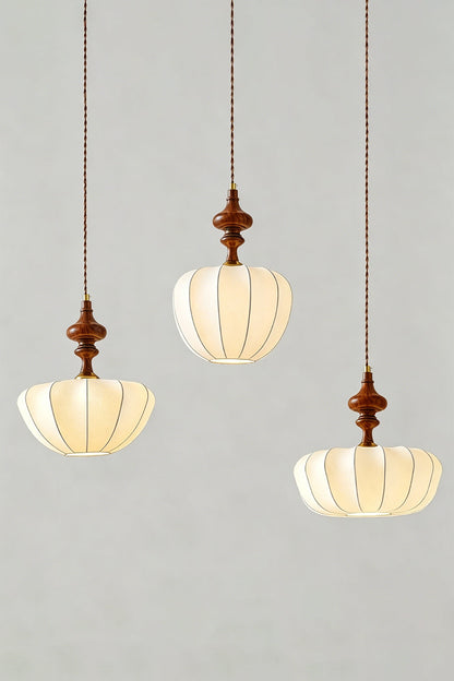Baird Mid-Century Silk Pendant Light trio featuring lobed silk shades and walnut-toned wooden spindles.