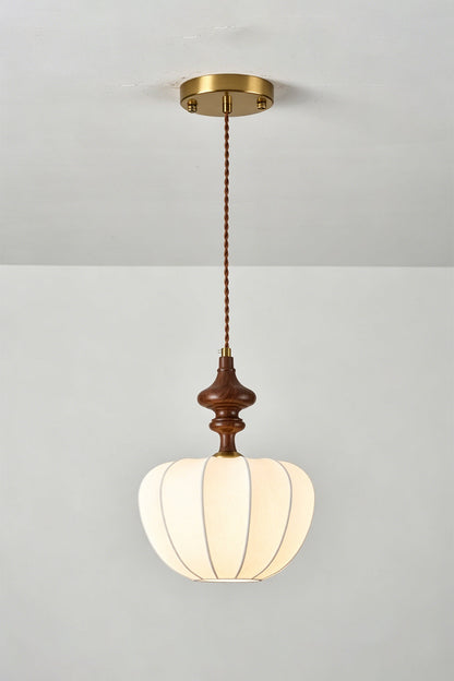 Baird Mid-Century Silk Pendant Light featuring a pumpkin-shaped silk shade and walnut-toned wooden spindle.